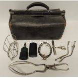 An early 20th Century doctor's leather Gladstone bag containing some childbirth instruments