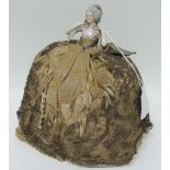 An early 20th Century German porcelain half doll with original crinoline pin cushion base, 20cms