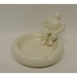 A Michelin promotional glazed pottery ashtray with figure of Michelin Man seated to one side, 9cms