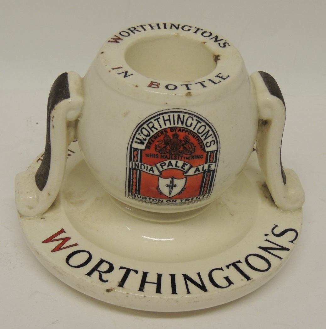 A Worthingtons "Pale Ale" bar vesta stand by Royal Doulton, with striker sides and circular base,