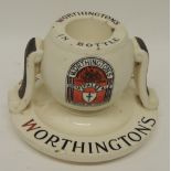 A Worthingtons "Pale Ale" bar vesta stand by Royal Doulton, with striker sides and circular base,