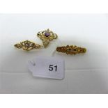 A collection of three 15ct gold brooches, one set with amethyst and pearls; another set with red and