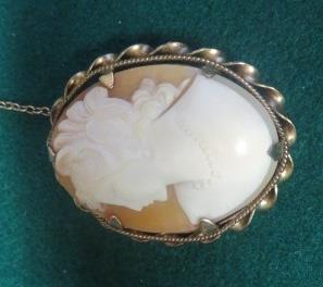 A well carved oval cameo brooch in an unmarked yellow metal fluted mount, 38mm x 31mm