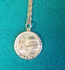 A hallmarked 9ct gold, Saint Christopher coin style pendant on a marked 375 Italy gold rope chain,