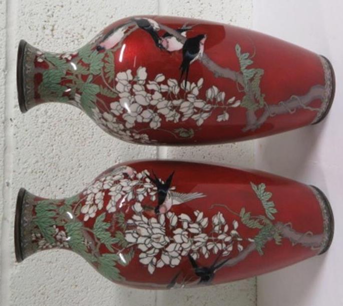 Pair of red ground cloisonné vases decorated with foliate and birds, 34cm high