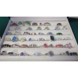 A boxed collection of over forty, mostly marked 925, gem set rings to include ruby, sapphire,