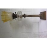 A brass and glass oil lamp, with Corinthian base with chimney and honeycomb shade decorated with