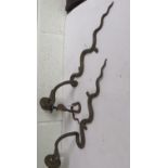 Pair of gilt metal wall candelabra in the form of snakes, supporting a single sconce, 54cm long