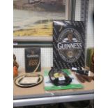 Collection of Guinness items to include a t-shirt, three bottle openers, a pair of salt and peppers,