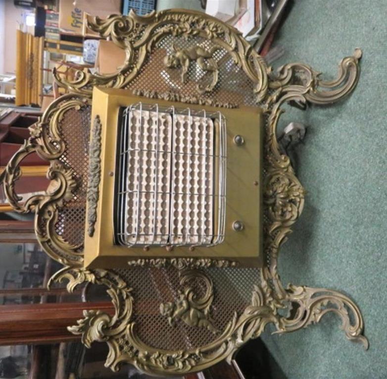 Ornate brass framed fire screen with later added fire