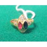 A marked 14ct gold Greek design cocktail ring set with a marquise cut ruby and sapphire and eight