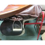 Pony saddle with cover on stand