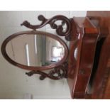 Victorian oval mirror on carved and shaped supports, with serpentine frontage with base with drawer,