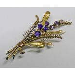 FLORAL BROOCH SET WITH AMETHYST & SEED PEARL & MARKED 9CT