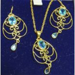 9CT GOLD OPEN WORK PENDANT SET WITH BLUE ZIRCON ON 9CT GOLD CHAIN & WITH PAIR MATCHING EARRINGS