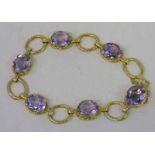 9CT GOLD BRACELET SET WITH 6 OVAL CUT AMETHYSTS