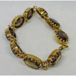 BRACELET SET WITH 9 OVAL-CUT SMOKEY QUARTZ TO 9CT GOLD CLAW SETTING