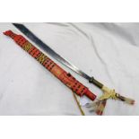 IVORY HANDLED DYAK MANDAU SWORD WITH 56CM FULLERED BLADE AND WICKER DECORATED WOODEN SCABBARD.