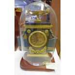 19TH CENTURY METAL CASED CLOCK WITH ORMOLU MOUNTS AND SILK SUSPENSION MARKED C & C IN GLASS DOME