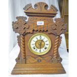 OAK CASED MANTLE CLOCK WITH CARVED DECORATION