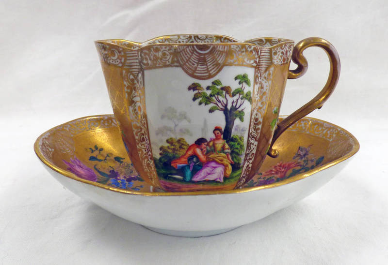 MEISSEN STYLE GILT DECORATED OVAL CUP AND SAUCER WITH PANELS OF COURTING COUPLES - BLUE CROSSED