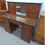 EARLY 20TH CENTURY WOOTON STYLE DESK WITH MIRROR FALL FRONT FLANKED BY DRAWERS OVER DRAWER FLANKED