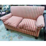 EARLY 20TH CENTURY OVERSTUFFED SETTEE IN PINK STRIPES AND BALL AND CLAW SUPPORTS