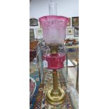 19TH CENTURY BRASS CORINTHIAN COLUMN OIL LAMP WITH CRANBERRY GLASS RESERVOIR & SHADE - 67 CM TALL