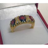 18CT GOLD GARNET AND DIAMOND SET RING.