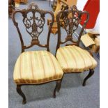 PAIR OF LATE 19TH CENTURY MAHOGANY HAND CHAIRS WITH DECORATIVE BACKS ON SHAPED SUPPORTS