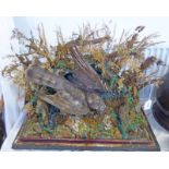 TAXIDERMY STUDY OF A BIRD IN SHRUBBERY