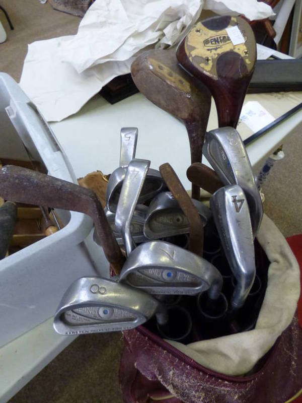 SELECTION OF GOLF CLUBS IN A GOLF BAG TO INCLUDE A HICKORY SHAFTED CLUB BY J.