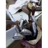 SELECTION OF GOLF CLUBS IN A GOLF BAG TO INCLUDE A HICKORY SHAFTED CLUB BY J.