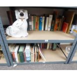 SELECTION OF VARIOUS BOOKS AND A WALLY DOG OVER TWO SHELVES