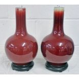 PAIR CHINESE RED FLAMBE WARE PORCELAIN VASES ON HARD WOOD STANDS 33 CM Condition Report: