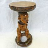 CONGO STOOL OF A CARVED STANDING FIGURE WITH OPEN BASE,