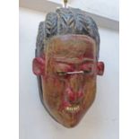 WEST AFRICAN MASK WITH CARVED HAIR AND TRACES OF RED PAINT TO FACE, 23.