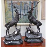 PAIR OF BRONZE STAGS MOUNTED ON AN OVAL MARBLE BASE. MARKED J. MOIGNIEZ.