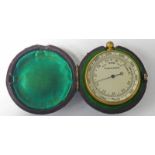 GILT METAL CASED BAROMETER IN LEATHER OUTER CASE