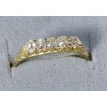 An old cut diamond ring, five old cut diamonds in a carved setting, total estimated diamond weight