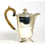A silver hot water jug, Sheffield 1938, with Celtic knot border, 20cm, 18.2ozt