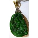 An 18 carat gold jade and diamond pendant, a carved jade plaque depicting birds and fruit to a