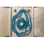 A turquoise bead necklace, a continuous knotted uniform strand of turquoise beads, each 7mm in