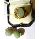 A 9 carat gold jade ring, an oval cabochon jade in a rubbed over setting, to a tapering shank with