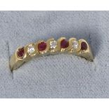 A 9 carat gold ruby and diamond half hoop ring, total estimated diamond weight 0.15 carat