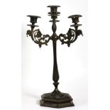 A 19th century cast iron candelabrum, three scroll arms, four light, hexagonal pierced base, 42cm in