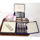 Two cased sets of silver-handled butter knives together with a set of six silver shell bowled coffee