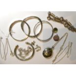 Four silver bangles, a silver locket on chain, two silver bracelets, a silver St. Christopher