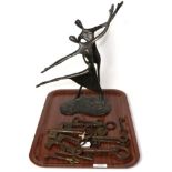 A cast sculpture of two figures dancing and a quantity of keys