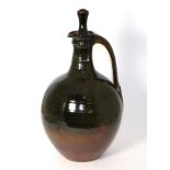 Joe (Joseph) Finch (British, b.1947): A stoneware bottle and stopper, tenmoku glaze, impressed JF